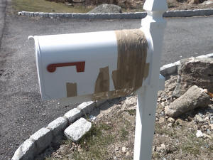 Taped mailbox in front of majestic house