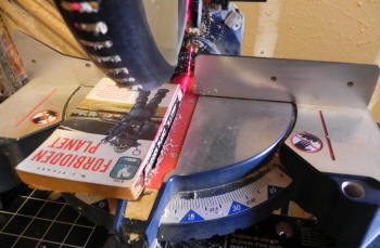 Circular saw aimed (with laser!) at the binding of Forbidden Planet, the soon-to-be-ex book