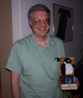 Rick, the winner of the Mulch Madness contest, with prize, an exploding penguin for the television set.