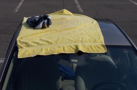 Towel on car, soakin' up the rays.