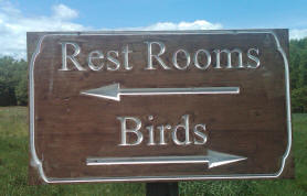 Raptor Trust information sign:  Birds to the right, rest rooms to the left